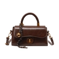 Retro brown leather crossbody bag with metal twist lock and woven bell charm accessory - Brown with Pendant