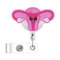 Detail of pink glitter acrylic uterus badge reel with retractable clip and smiling face - Uterus