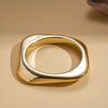 Macro view of minimalist irregular geometric gold cuff with polished mirror finish - Gold Geometric Square
