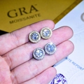 Classic round moissanite stud earrings in gold and silver finish held by model - Round Moissanite-Look Studs - Platinum Color (ED173)