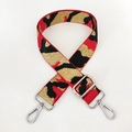 Close-up of thick camouflage bag strap with red, black, and gold metallic woven patterns - Red Gold Thread + Silver Buckle