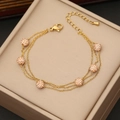 Bracciale multistrato in acciaio dorato con sfere in argilla e strass rosa - Rosa Pesca