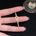 Macro shot of gold plated gourd buckle bracelet with white cubic zirconia stones - Rose Gold