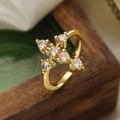 Gold plated geometric cross ring with round cubic zirconia on a rustic wooden frame - Gold Cross (14233)