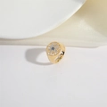 Detailed view of gold sunburst signet ring with blue and white zircon inlay details - Sunburst Emblem Signet Style / Gold