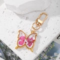 Handmade butterfly resin keychain with real pink dried flowers and gold metal frame - Rose Red Flower Butterfly