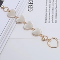 Golden alloy heart-shaped phone chain charm with five cream-colored solid heart pendants - Off-white