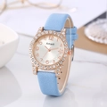Detailed close-up of a light blue suede watch strap with a crystal-studded rose gold bezel - Sky Blue