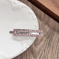 Detailed view of pink rhinestone geometric metal hair clip on a white ceramic tray - Rectangle / Pink