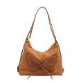 Brown suede tote bag with large butterfly applique and drawstring detail in studio shot - Brown