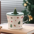 Close-up of ceramic Christmas mug featuring festive Santa patterns and a 3D tree lid handle - Christmas Tree (With Lid)