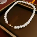 Elegant white pearl necklace with a polished gold magnetic ball clasp in a brown tray - 10mm / White