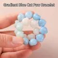 Handheld view of a beaded bracelet featuring gradient blue and white cat paw charms - S067-cat Paw [gradient Blue] Bracelet #sz541