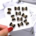 Set of 10 mini black and gold bow brooches for women necklines shown on card - Bowknot Style