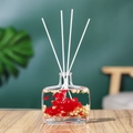Reed diffuser in square glass bottle with red and white dried flowers on wooden table - English Pear & Freesia - 100ml