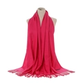 Solid deep pink cashmere-feel scarf with tassels draped on a model mannequin - Rose Red