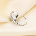 Macro shot of silver teardrop ring with sparkling crystals on champagne satin fabric - Silver White Zircon (KR112028-HR)
