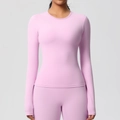 Close-up of seamless stitching and soft matte texture on light pink yoga long sleeve top - Sakura Pink