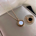 Detail view of double-sided rose gold necklace with white shell and black onyx inlays - Rose Gold Double Sided Roman Necklace