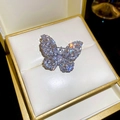 Close-up of luxury butterfly brooch with sparkling zircons and gold plating in gift box - Silver