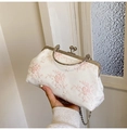 Elegant white lace evening bag with vintage metal frame and round handle in hand - Pink