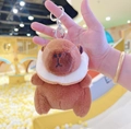 Close-up of brown plush capybara keychain with white scarf and silver metal clasp - Donut Dark Brown + Silver Clip