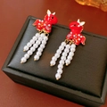 Detail of red enamel horse earrings with white pearl tassels on a black display box - Silver Pin Red Horse Pearl Tassel Style / Red/White/Gold