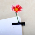 Detail of a red gradient daisy hair clip with yellow pistil and black metal alligator clip - Sun Flower Red