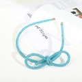 Sparkling light blue rhinestone bow headband with elegant gold-tone metal end caps - Figure 8 Knot Full Rhinestone Headband / Lake Blue Rhinestone