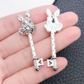 Macro view of vintage silver rabbit key pendant showing heart cut-out and texture - Rabbit Head Key (8387)