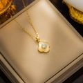 Luxurious gold clover pendant necklace with zircon crystals on a beige jewelry display box - 8802 Gold White