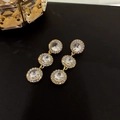 Elegant gold drop earrings with three circular crystal pendants on a textured black background - Steel Post Triple Ring (17#)