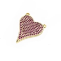 Macro shot of heart-shaped pendant with magenta cubic zirconia and gold-plated bail - Rose Red