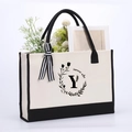 Beige cotton canvas tote bag with black base and ribbon featuring letter Y print - Letter-Y
