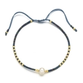 Detail of adjustable blue braided bracelet with white pearl and gold metal beads - Deep Blue (Sl100)
