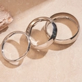 Close-up of three layered silver geometric metal bangles on a textured stone surface - Silver (3-Piece Set)