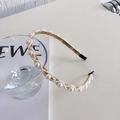 Elegant gold metal headband with various sized pearls arranged in a minimalist wave style - Cross Pearls (Gold Crossed Wave Pearl)