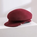 Side view detail of a classic burgundy wool newsboy cap on a white studio block - Adjustable / Burgundy