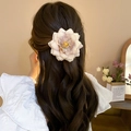 Delicate cream and pink fabric flower hair claw clip worn by a model in a warm setting - Pale Yellow Gradient Flower (Duckbill Clip)