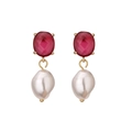 Detail of red oval-cut gemstone earrings with elegant white baroque pearls and gold plating - Red