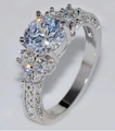 Elegant silver ring with a large round cubic zirconia and side stones in classic style - Ur0530
