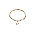 Detail view of gold bead bracelet with pearls and horseshoe charm with colored crystals - Letter U