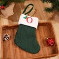 Green knit Christmas stocking featuring embroidered red letter O with festive holly detail - Letter O