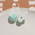 Macro shot of mint green and white resin heart charms for DIY jewelry making - Light Green Heart