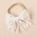 Close-up of baby nylon headband with handcrafted white lace embroidery floral bow - White