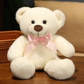 Classic white teddy bear plush toy with pink ribbon bow on dark wood tabletop - 35cm / Off-white