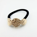Close-up of black elastic hair tie featuring three golden hammered metal textured beads - Triple Circle Hammered Decoration (Hair Tie 5)