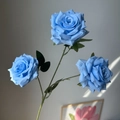 Lifelike artificial bouquet featuring three blooming blue roses with green leaves - Blue