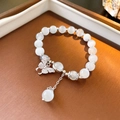 Elegant beaded bracelet featuring white cat eye stones and a zircon butterfly charm - White Cat's Eye Stone / White Butterfly Pendant (55 Bracelet-White)