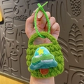 Handmade green knitted mini pouch with a plush Christmas tree charm and star detail - Christmas Tree